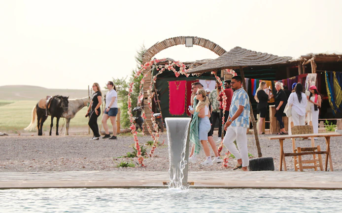Safari lunch with camel ride and swimming pool in Agafay desert setting.
