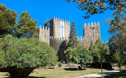 Guimaraes Castle surrounded by trees, Guimaraes, Minho province, Portugal.