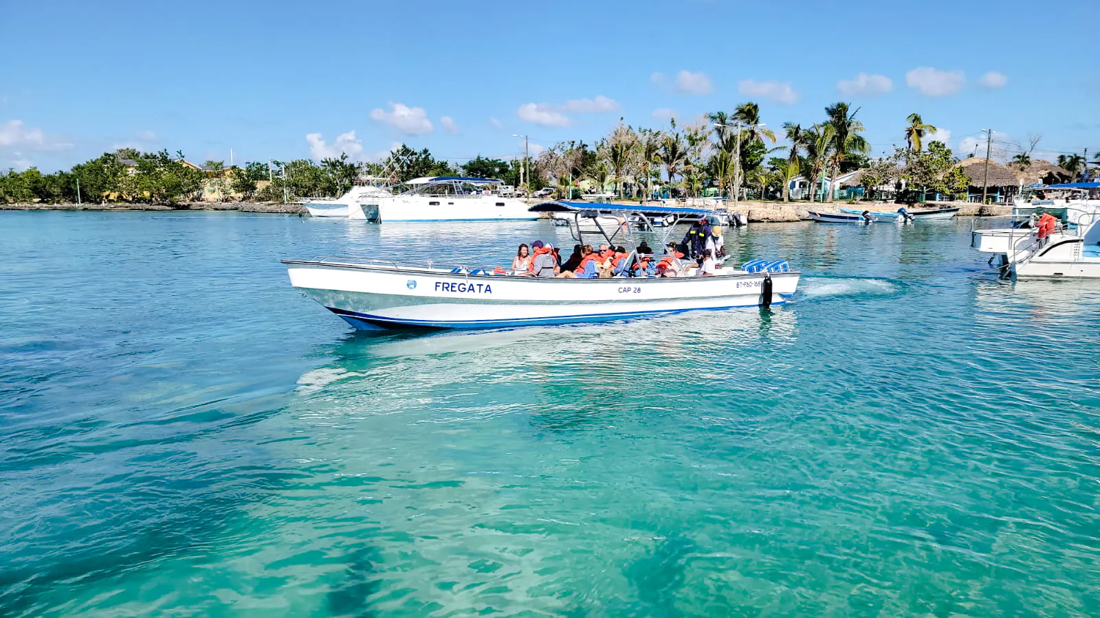 Boat with tourists on clear waters during Catalina Island day trip from Santo Domingo, Punta Cana.