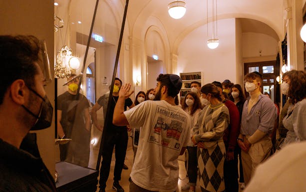 Visitors listening to a guide inside Stadttempel, Vienna.