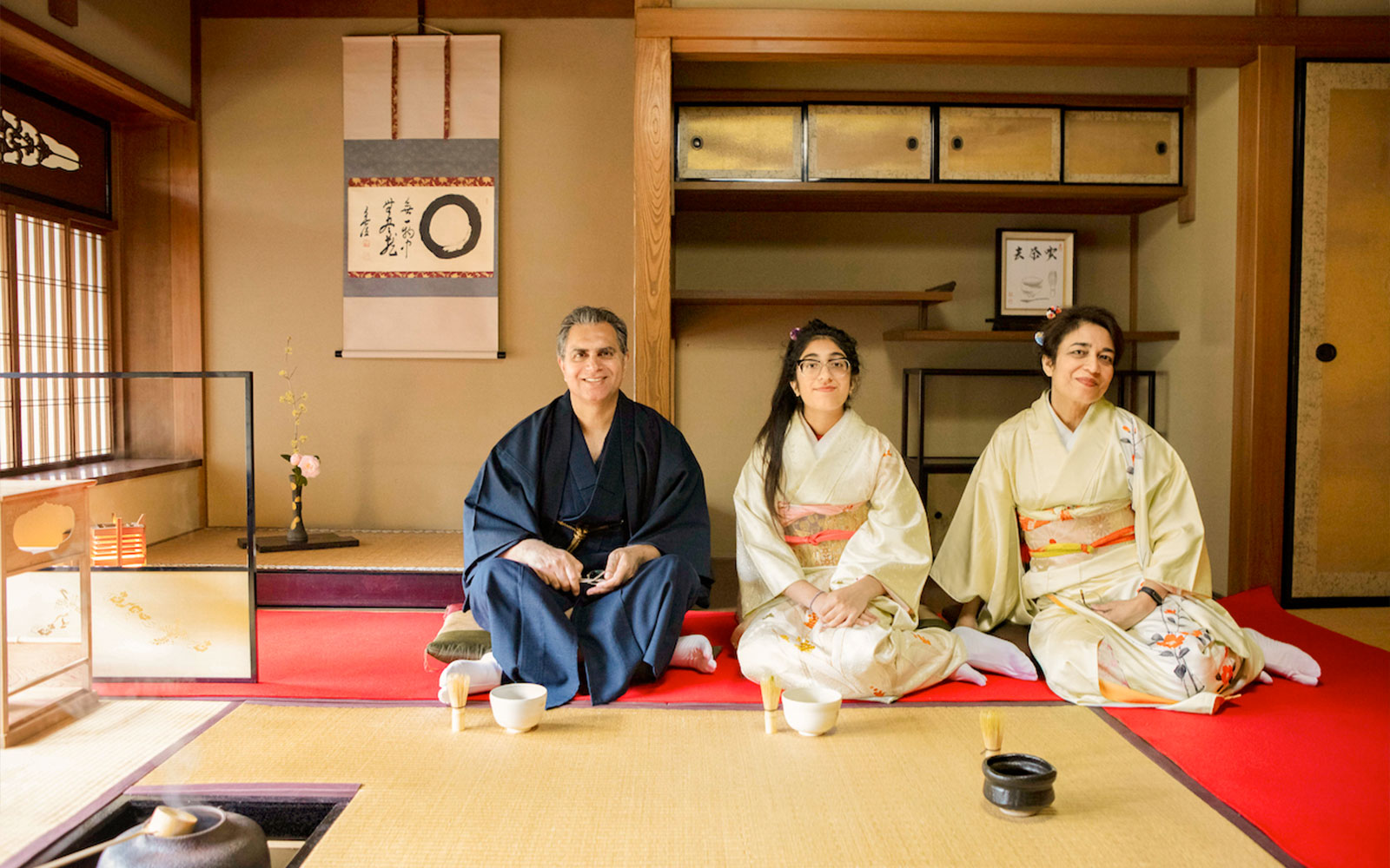 Participants in traditional attire at a tea ceremony in a Kyoto teahouse.