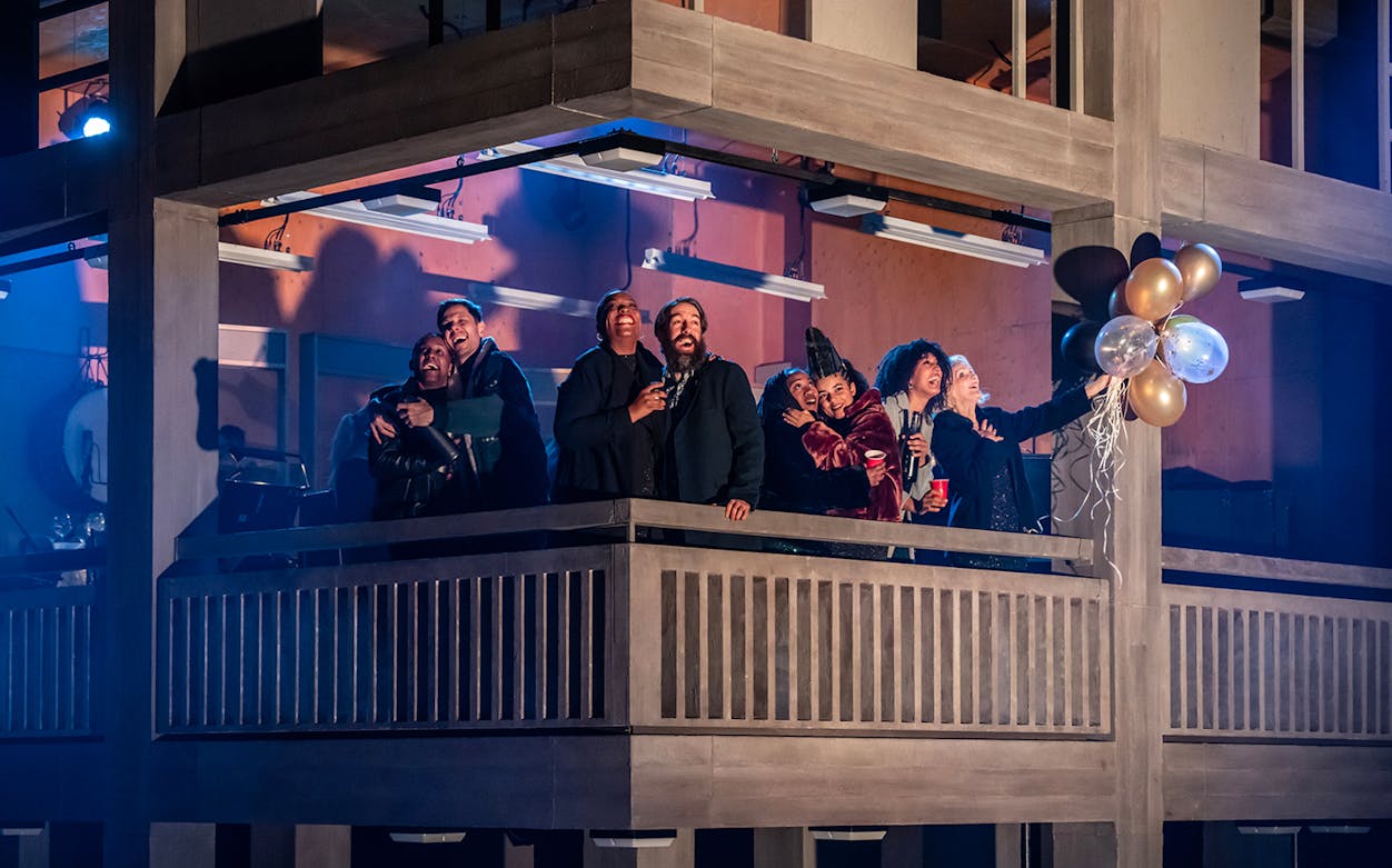 Group of people celebrating on a balcony during Standing at the Sky's Edge Westend performance.