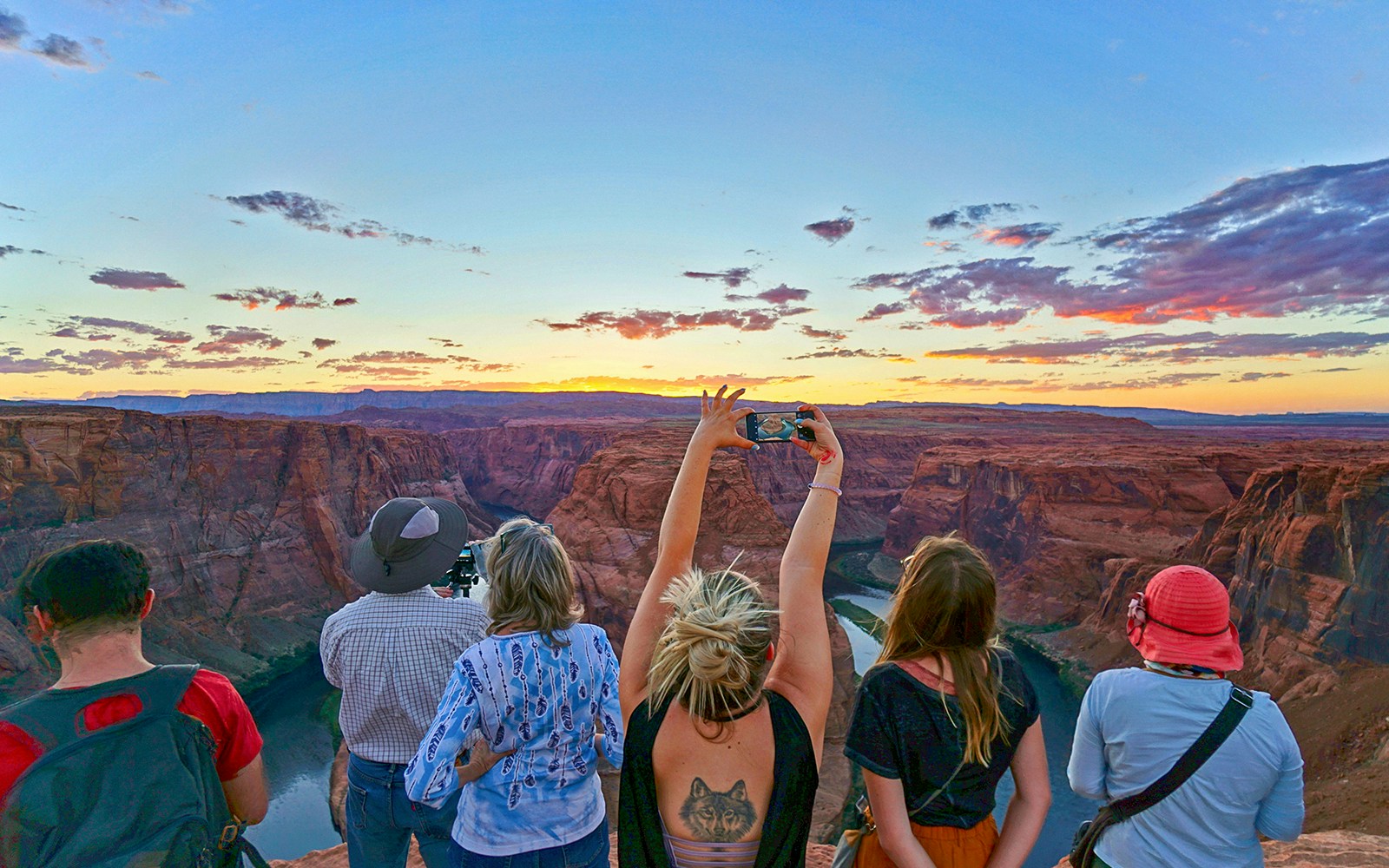 travelers enjoying sunset together at horseshoe bend