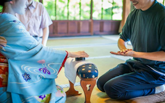 Cultural ritual at a traditional Zen temple in Kyoto with participants engaging in a hand game.