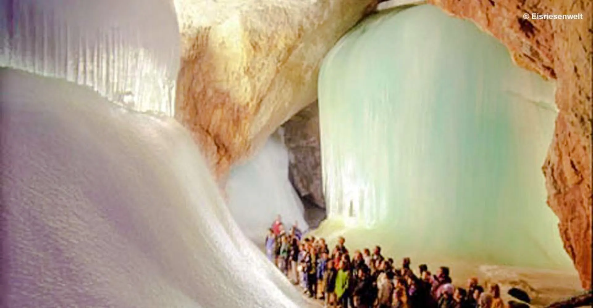 Visitors exploring Werfen Ice Caves, Salzburg, surrounded by large ice formations.