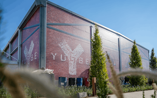 YULLBE PRO VR Experience building exterior with logo on brick wall.