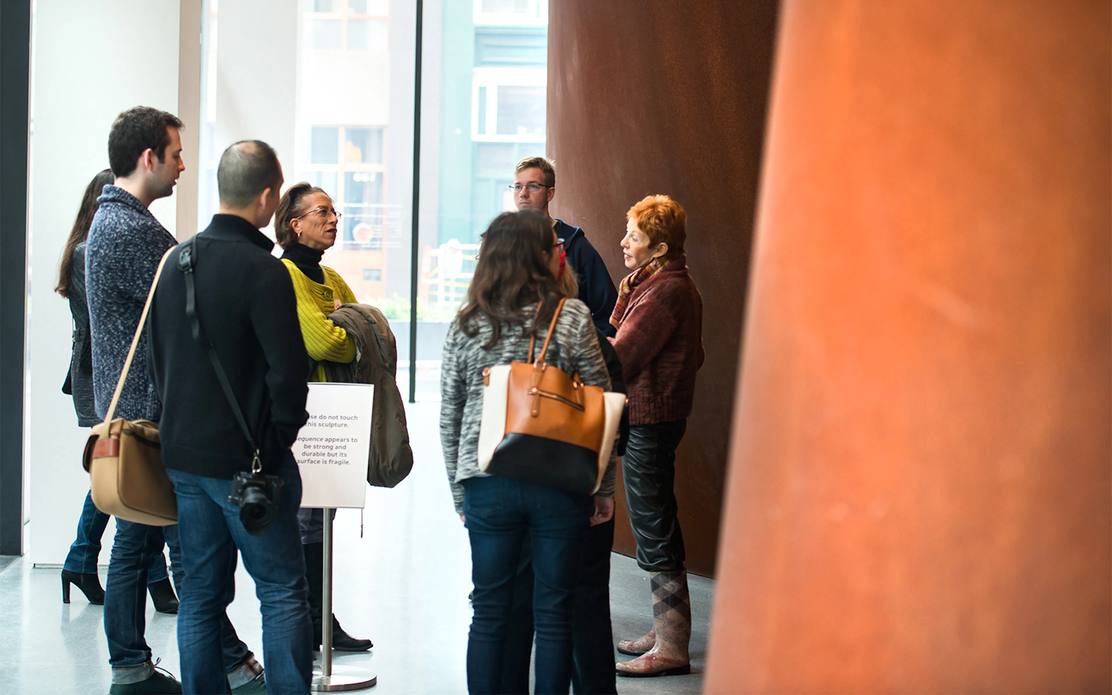 Visitors exploring Richard Serra's Sequence at San Francisco Museum of Modern Art.