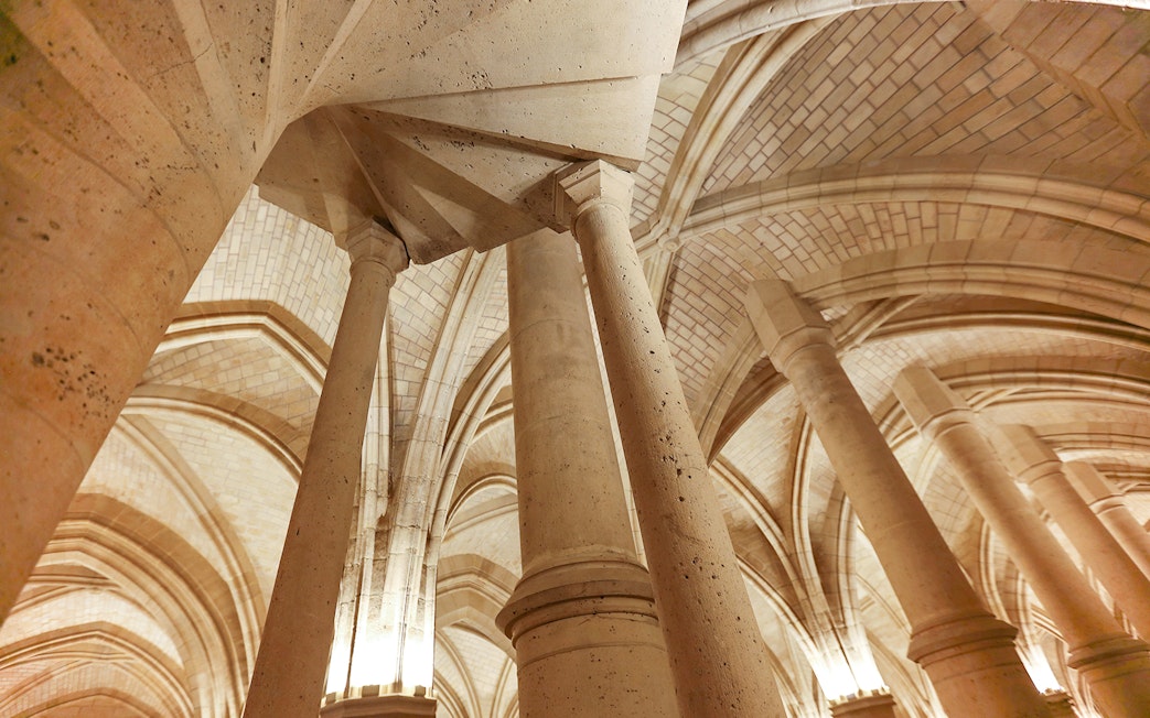 Sainte Chapelle stone columns and vaulted ceilings in Paris.