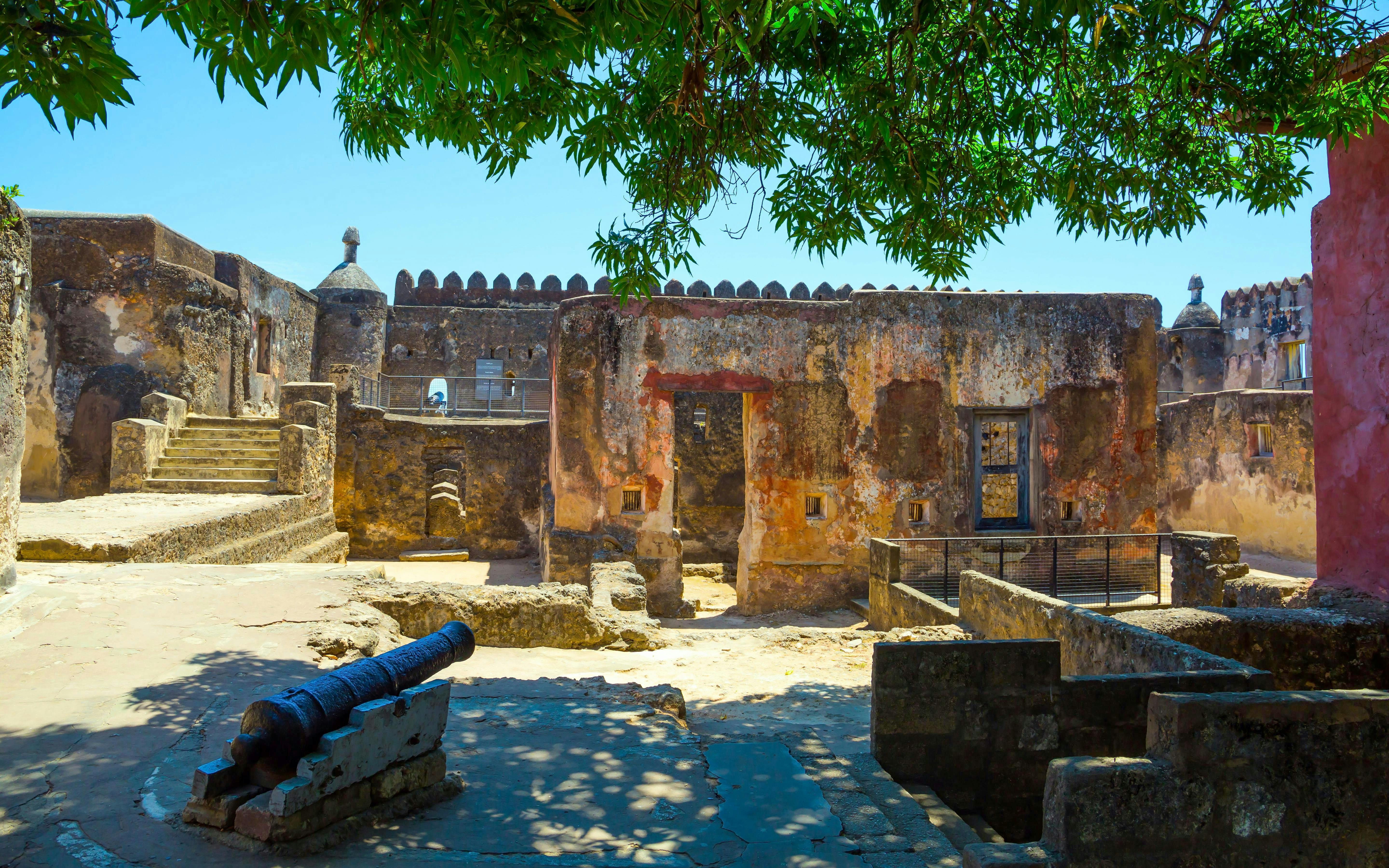Fort Jesus courtyard with ancient cannon and stone walls in Mombasa, Kenya.