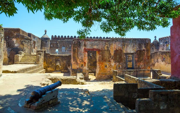 Fort Jesus courtyard with ancient cannon and stone walls in Mombasa, Kenya.