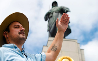Tour guide gesturing near Soviet War Memorial in Berlin during Third Reich and Cold War walking tour.