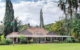 Karen Blixen Museum in Nairobi with lush gardens and Kenyan flag.