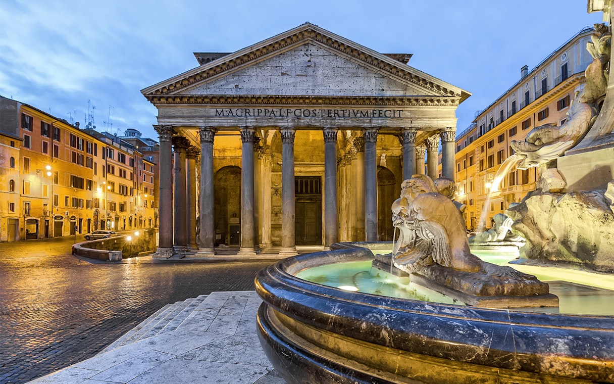Pantheon in Rome with fountain in foreground at sunset.