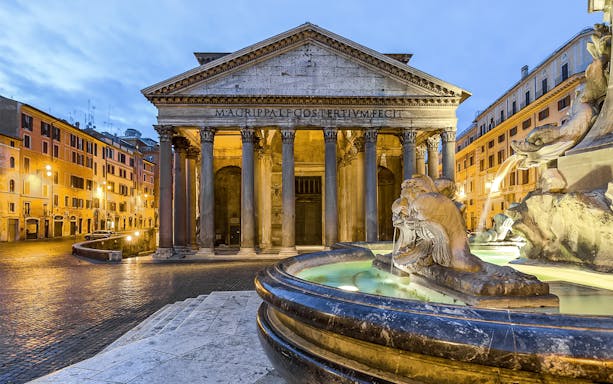 Pantheon in Rome with fountain in foreground at sunset.