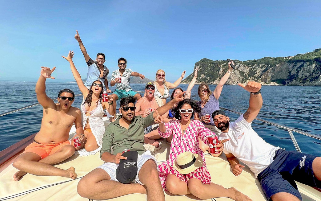 Group enjoying a boat tour near Capri's coastline, Sorrento.