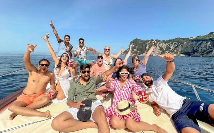 Group enjoying a boat tour near Capri's coastline, Sorrento.