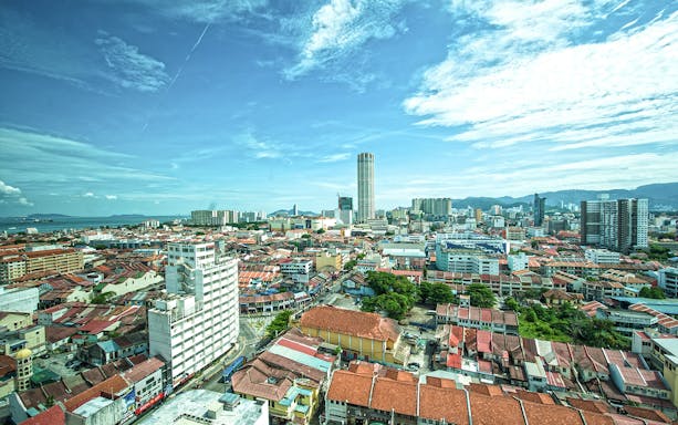 Aerial view of George Town, Penang with Komtar Tower and surrounding cityscape.