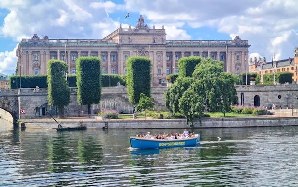 Sightseeing boat tour passing by Parliament House in Stockholm.