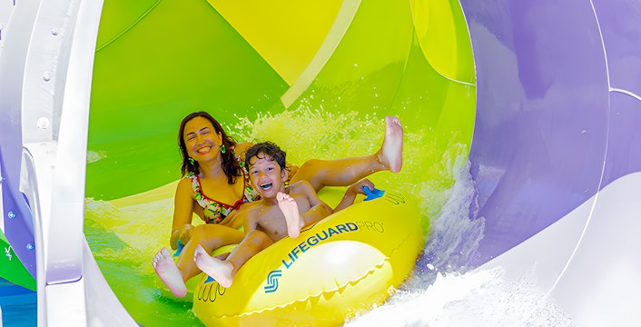 Woman enjoying a water slide at Aquopolis Villanueva.
