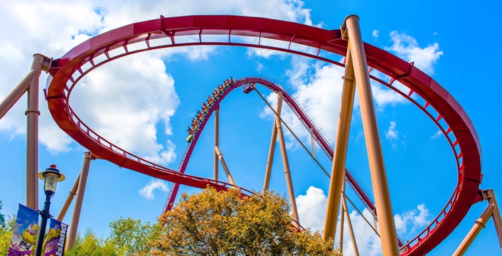 Diamondback Rollercoaster loop at King's Island, Six Flags against blue sky.