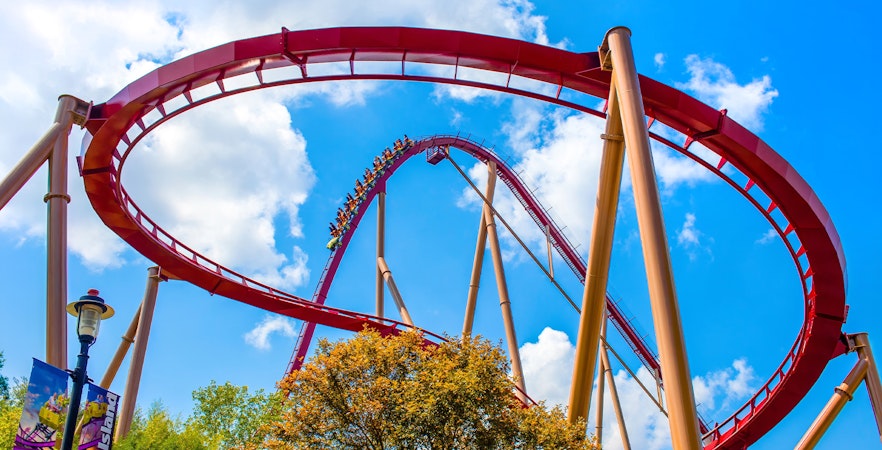 Diamondback Rollercoaster loop at King's Island, Six Flags against blue sky.