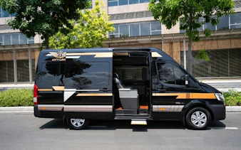 Minibus for Hue to Da Nang route parked on a street in Dubai.