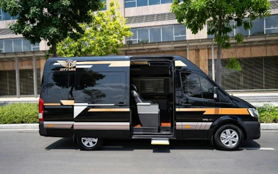 Minibus for Hue to Da Nang route parked on a street in Dubai.