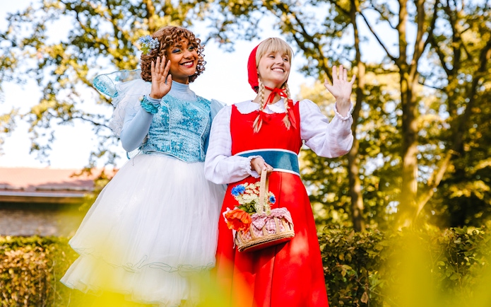 Characters in fairy tale costumes waving at Efteling Theme Park, Amsterdam.