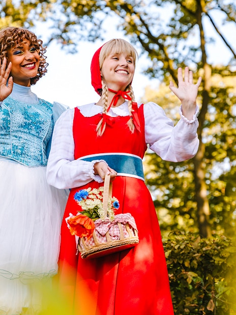 Characters in fairy tale costumes waving at Efteling Theme Park, Amsterdam.
