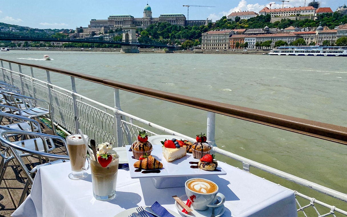 Brunch on Danube River cruise with Budapest Parliament in background.