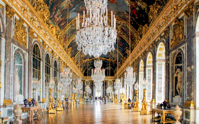 Hall of Mirrors, Versailles Palace, ornate chandeliers, gilded decor, arched mirrors, France.