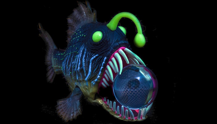 Anglerfish swimming in a dimly lit aquarium exhibit.