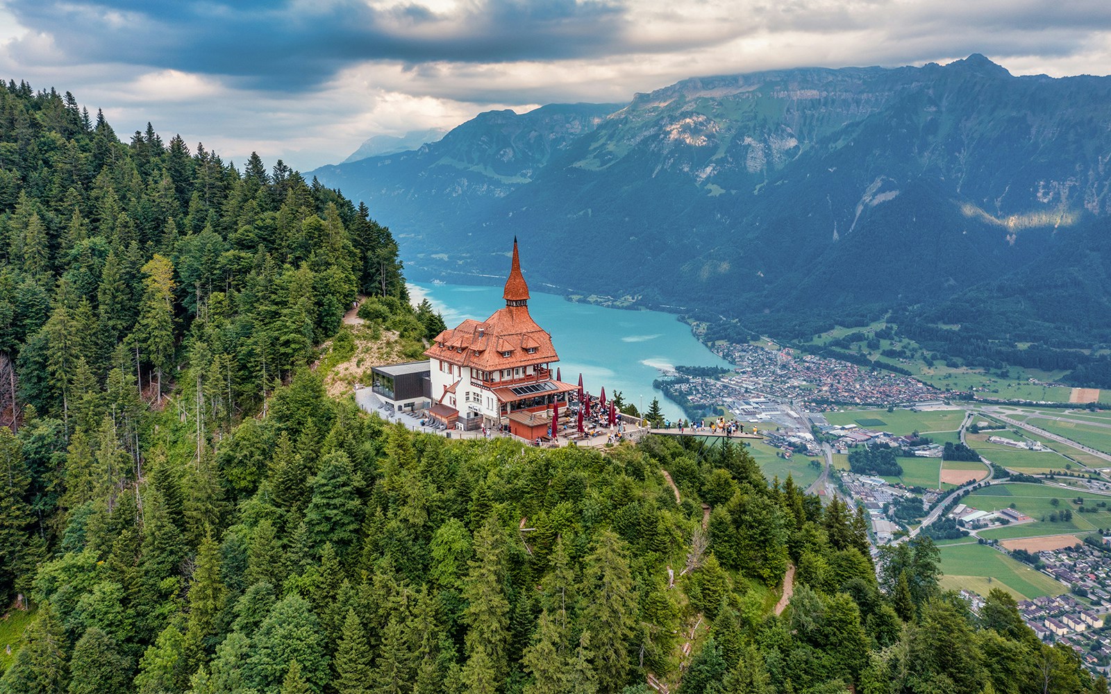 Harder Kulm viewpoint overlooking Interlaken and Lake Thun in summer, Swiss Alps.