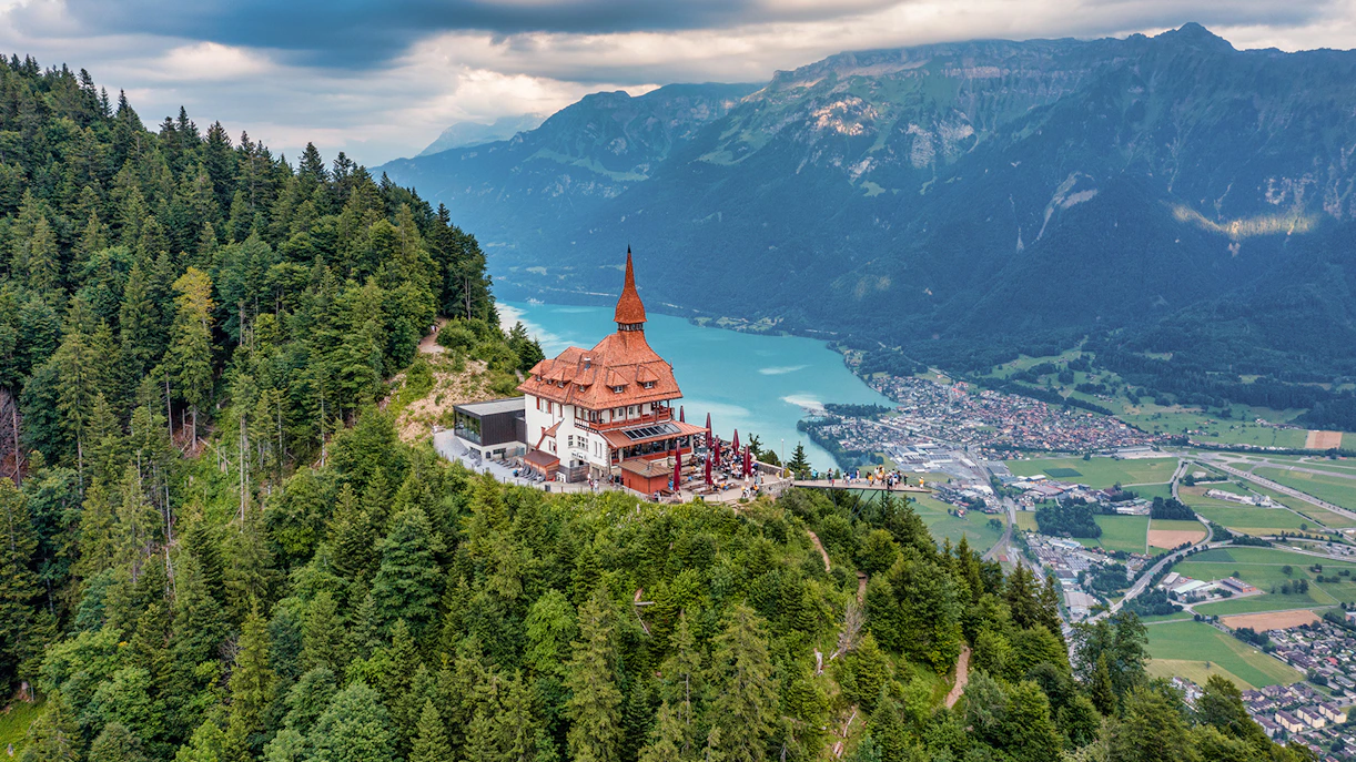Harder Kulm viewpoint overlooking Interlaken and Lake Thun in summer, Swiss Alps.
