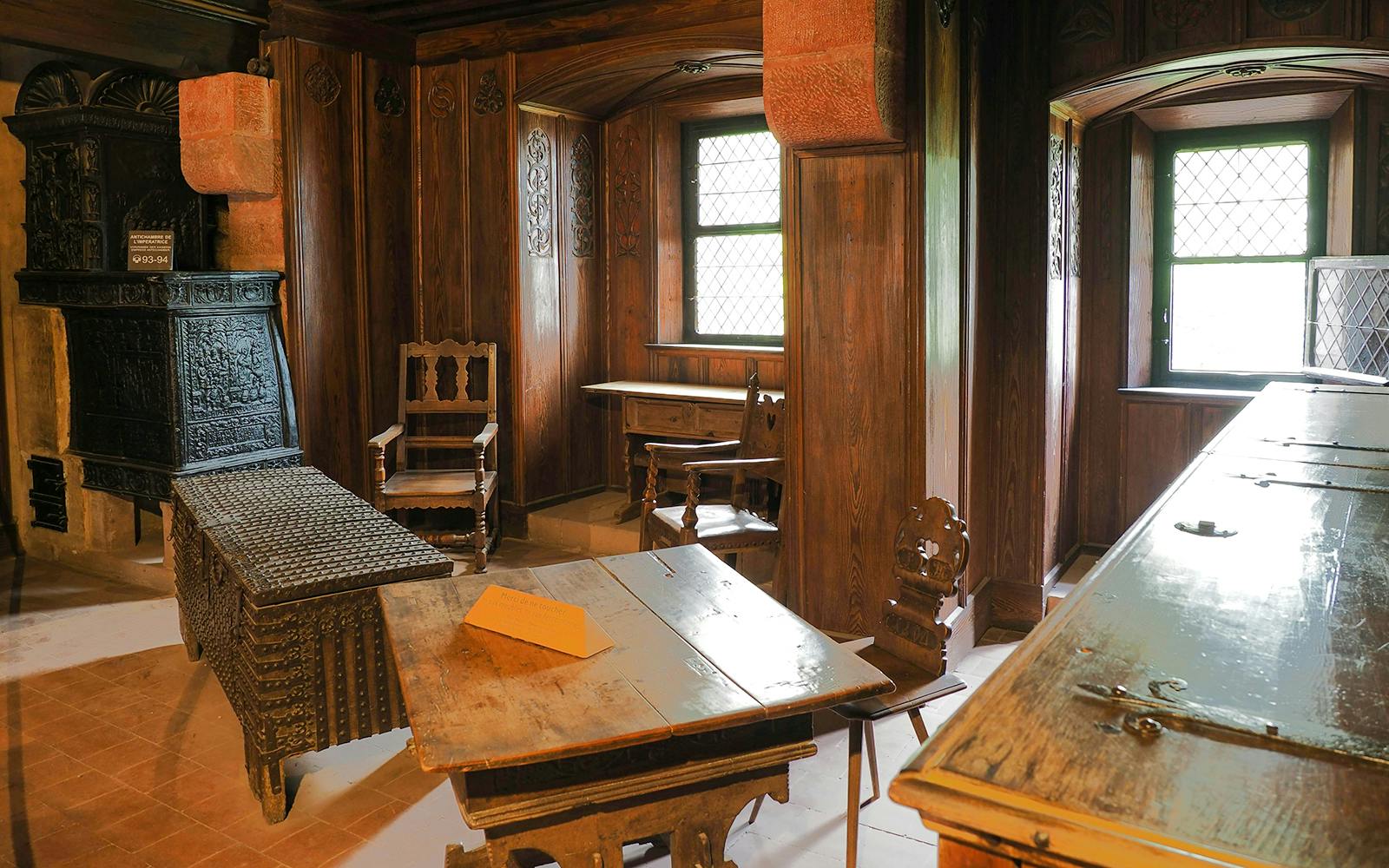 Chamber interior with wooden furniture in Koenigsbourg Castle, Alsace, France.