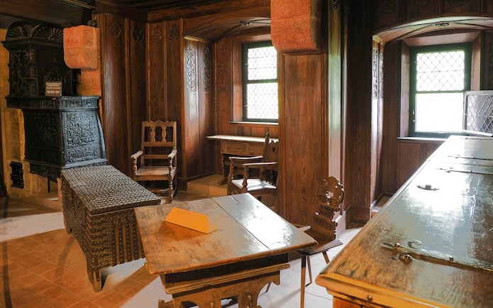 Chamber interior with wooden furniture in Koenigsbourg Castle, Alsace, France.