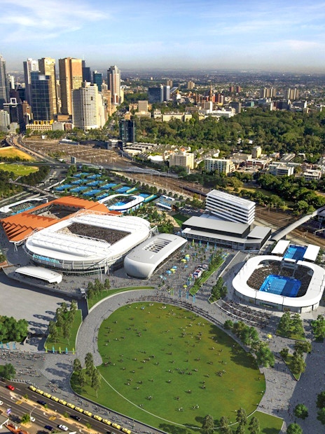 Aerial view of Melbourne sports precinct with stadiums and city skyline.