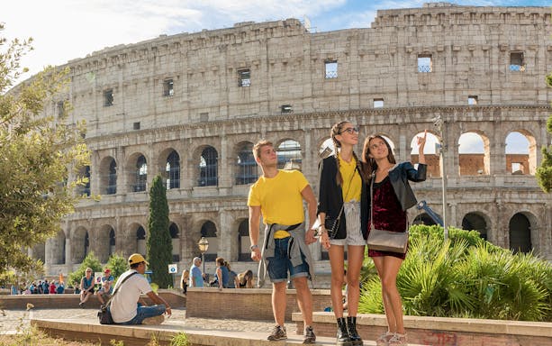 Tourists exploring the Colosseum in Rome during a guided tour.