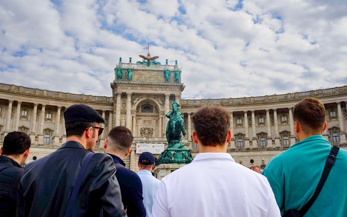 Tourists at Hofburg Palace in Vienna during a guided walking tour.