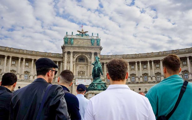 Tourists at Hofburg Palace in Vienna during a guided walking tour.