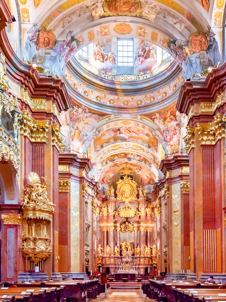Interior of Melk Abbey with ornate gold decorations, part of the Danube Valley day trip from Vienna.
