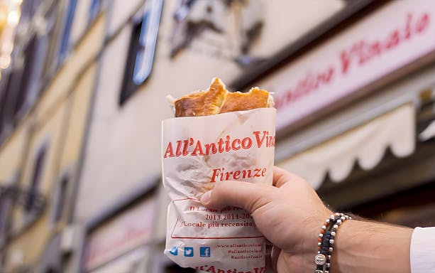 Hand holding sandwich from All’Antico Vinaio in Florence.