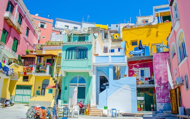 Colorful buildings in Positano, Italy, viewed from a street on a sunny day.