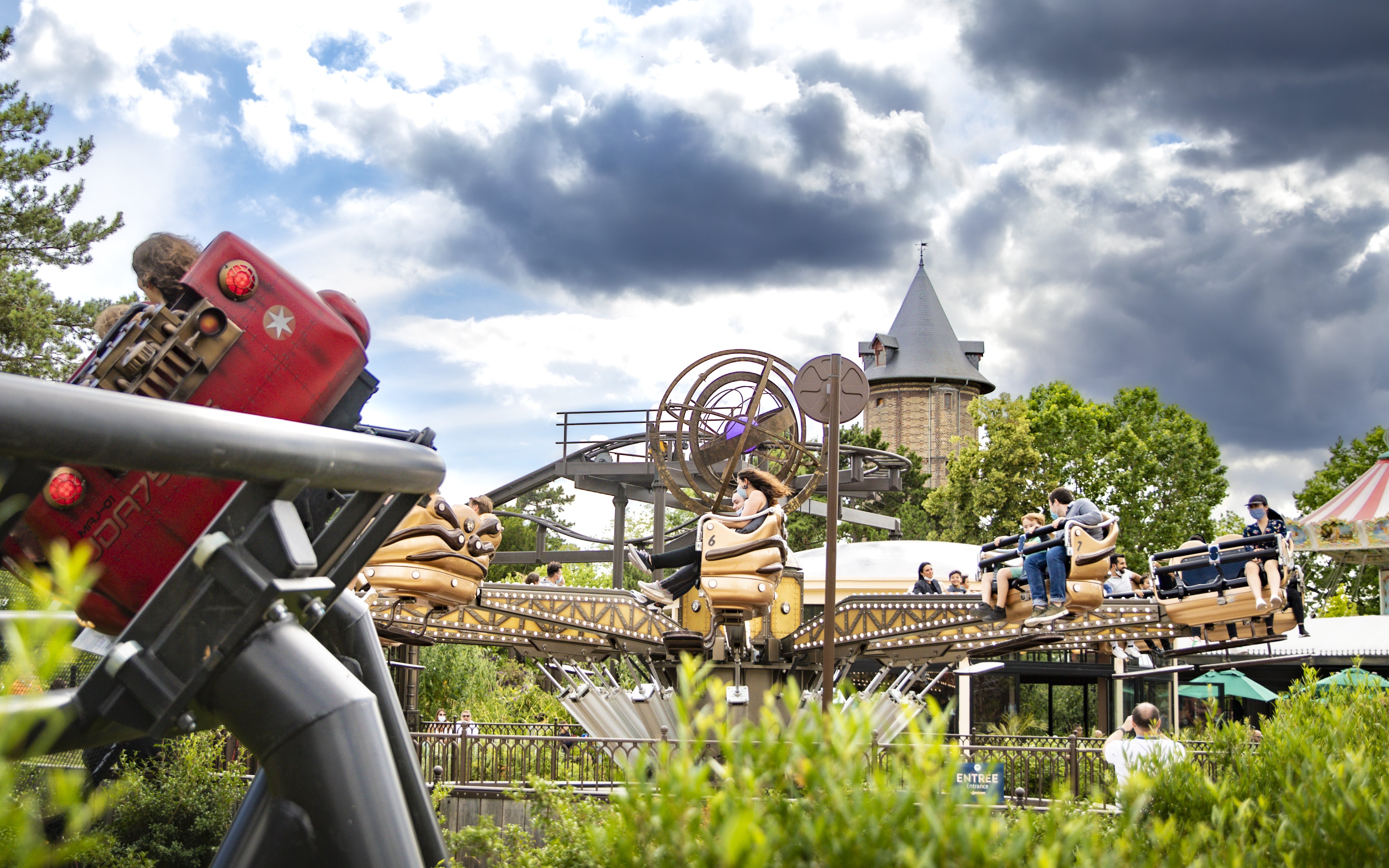 Visitors enjoying a ride at Le Jardin d'Acclimatation amusement park in Paris.