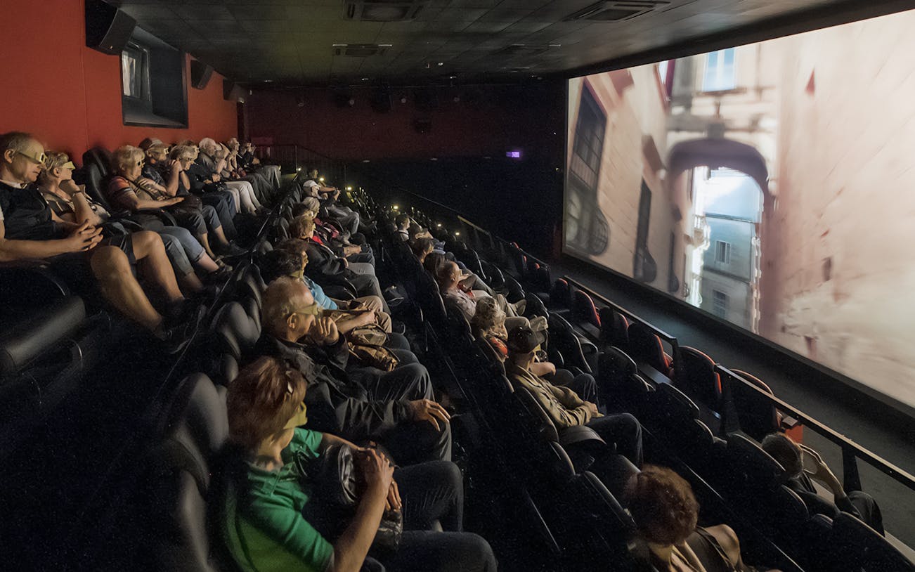 Audience watching Malta 5D audio-visual show in a theater.