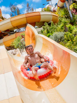 Visitors on a water slide at Aqualand Costa Adeje, Tenerife, Spain.