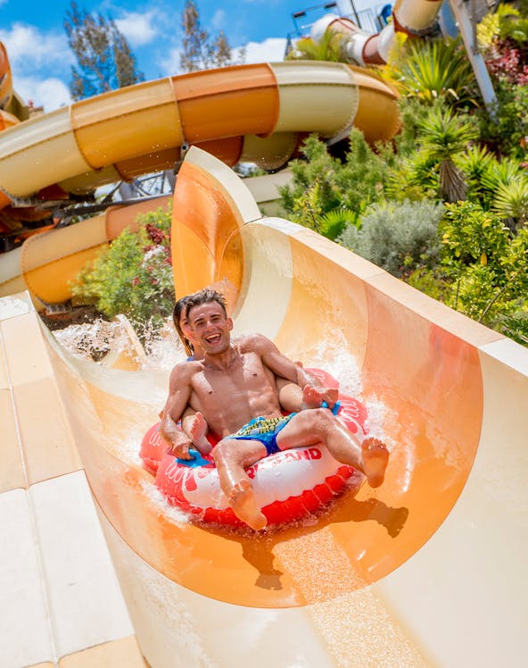 Visitors on a water slide at Aqualand Costa Adeje, Tenerife, Spain.