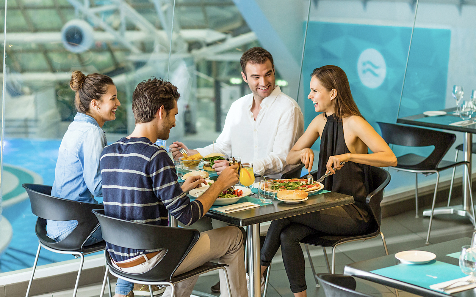 Group dining at Caldea spa restaurant, Andorra, enjoying meals by the pool.