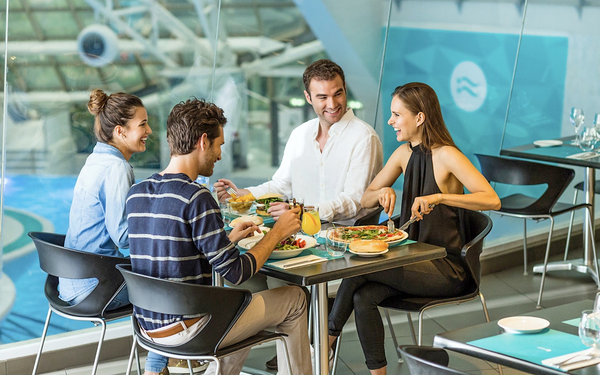 Group dining at Caldea spa restaurant, Andorra, enjoying meals by the pool.