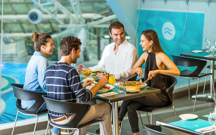 Group dining at Caldea spa restaurant, Andorra, enjoying meals by the pool.